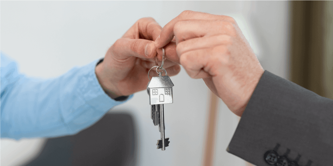 Nahaufnahme einer Haustürschlüsselübergabe.